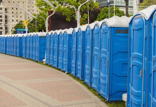 a line of brightly-colored portable restrooms, perfect for outdoor festivals and concerts in Campbellsburg IN